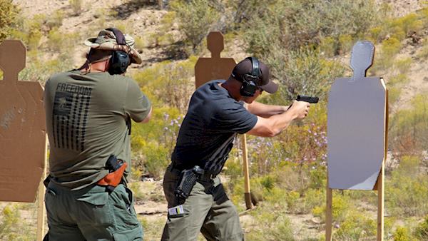 Tactical Police Competition Competitor Firing on a Silhouette Target on an Outdoor Range